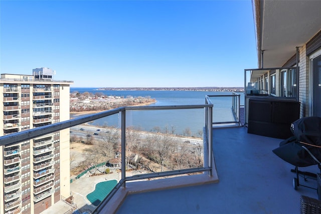 balcony featuring a water view and a view of city