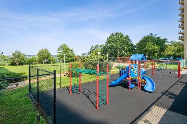 community playground with fence and a yard