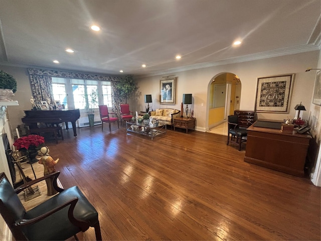 living room with arched walkways, hardwood / wood-style floors, ornamental molding, and recessed lighting