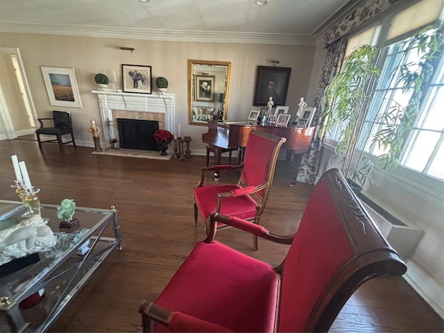 living area with wood finished floors, crown molding, baseboards, and a premium fireplace