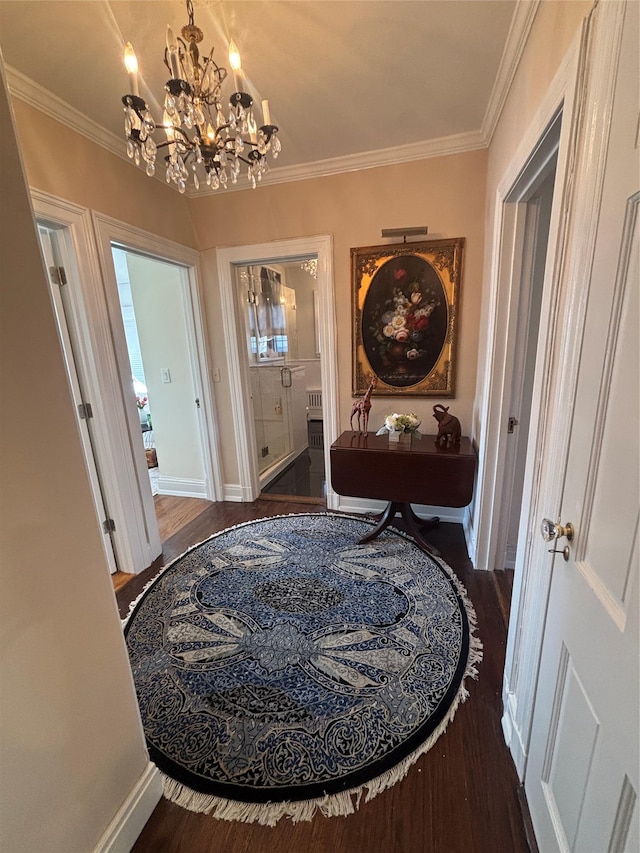 hall with baseboards, wood finished floors, and crown molding