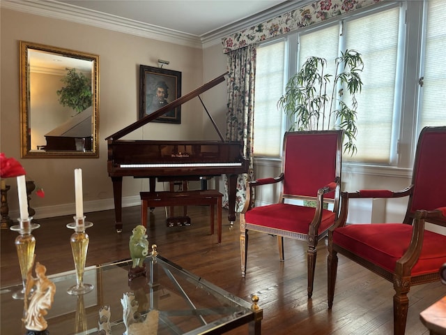 sitting room with wood-type flooring, crown molding, and baseboards