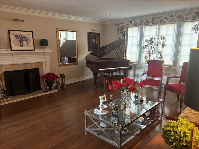 living room with ornamental molding, wood-type flooring, a fireplace, and baseboards