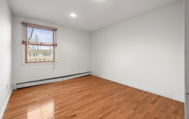 23 Franko Ln, Setauket, NY 11733 - spare room with baseboard heating, light wood-type flooring, and recessed lighting