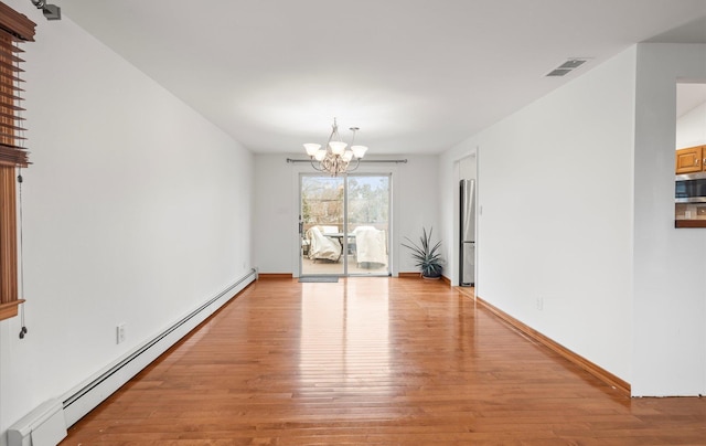 23 Franko Ln, Setauket, NY 11733 - spare room featuring a baseboard radiator, light wood-type flooring, and a chandelier