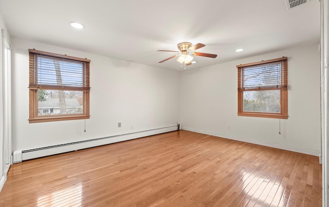 23 Franko Ln, Setauket, NY 11733 - empty room with a baseboard radiator, light wood finished floors, a ceiling fan, plenty of natural light, and recessed lighting