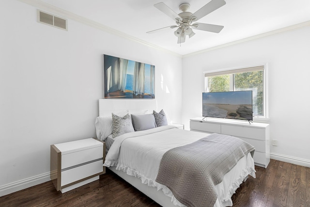 bedroom featuring crown molding, wood finished floors, visible vents, and baseboards