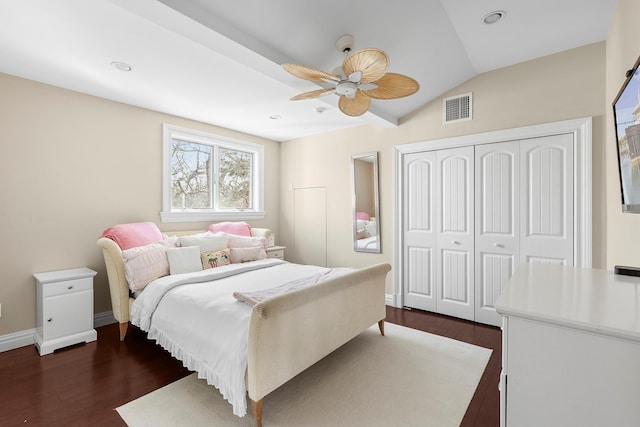 bedroom featuring lofted ceiling, dark wood finished floors, visible vents, and baseboards