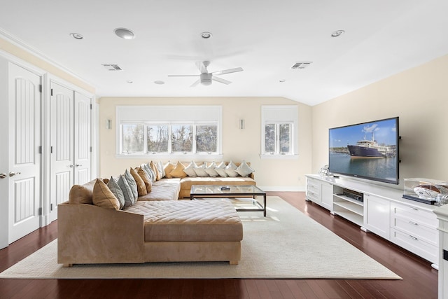 living area featuring visible vents and dark wood-style flooring