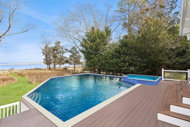 view of pool with a pool with connected hot tub and a deck with water view