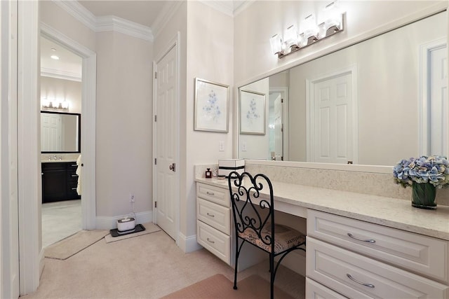 office featuring baseboards, ornamental molding, built in desk, and light colored carpet