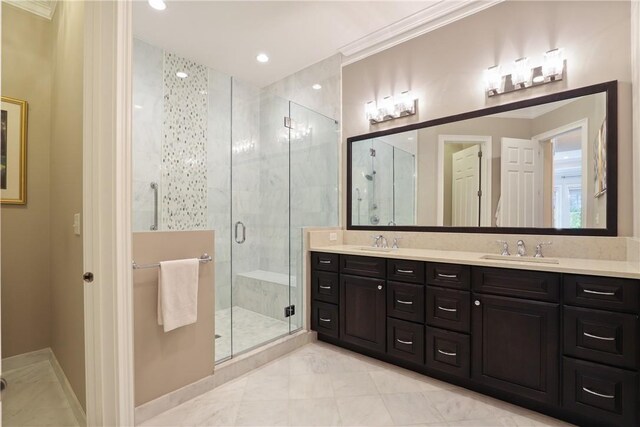 full bathroom with a stall shower, a sink, baseboards, and double vanity