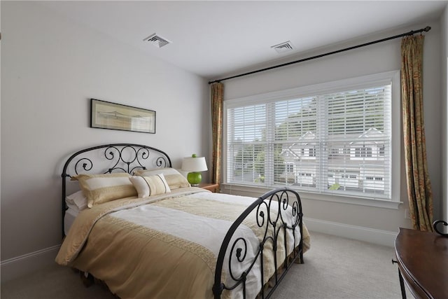 bedroom with baseboards, visible vents, and carpet flooring