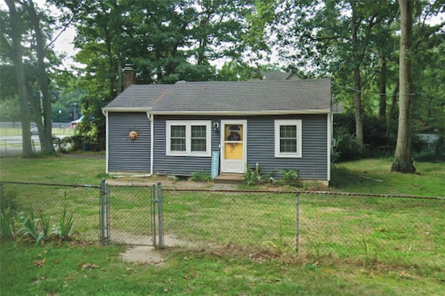 bungalow-style home with a fenced front yard, a front yard, a gate, and a chimney