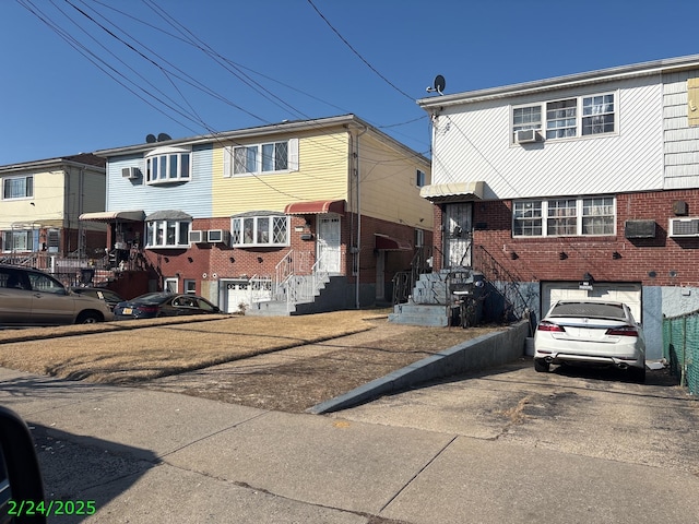 view of property with cooling unit, brick siding, and entry steps