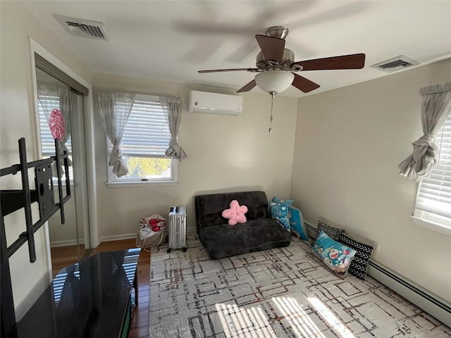 interior space featuring baseboard heating, a wall mounted air conditioner, wood finished floors, and visible vents