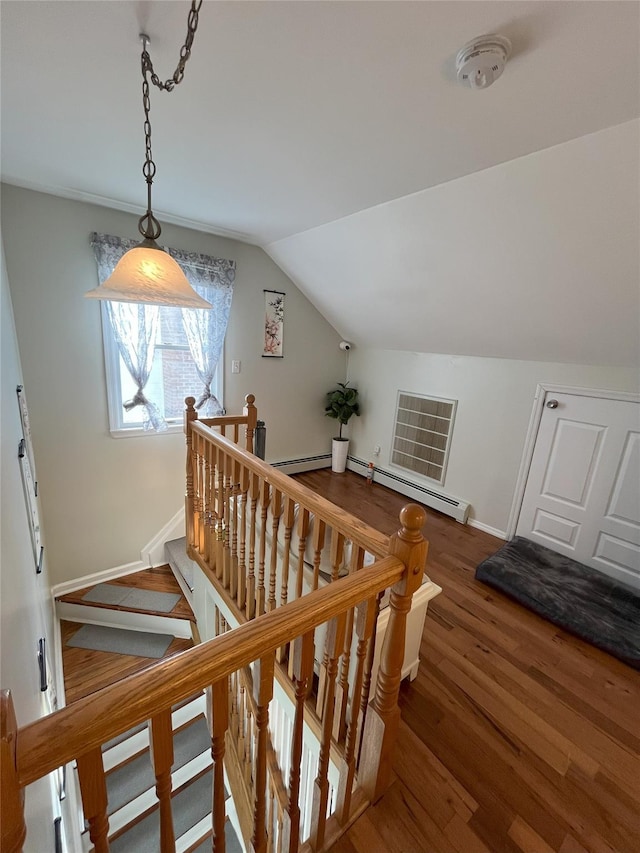 stairs with vaulted ceiling, baseboards, and wood finished floors