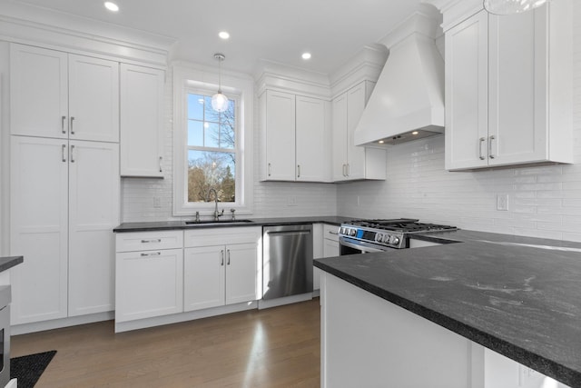 kitchen featuring dark wood-style flooring, a sink, white cabinets, appliances with stainless steel finishes, and custom range hood