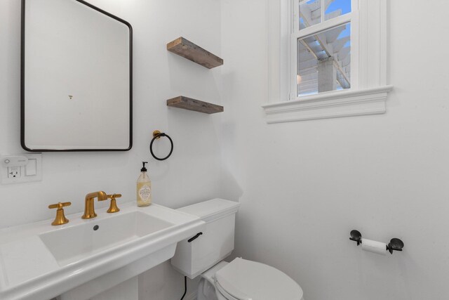 half bathroom featuring a sink and toilet