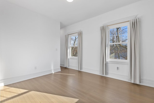 empty room with wood finished floors and baseboards