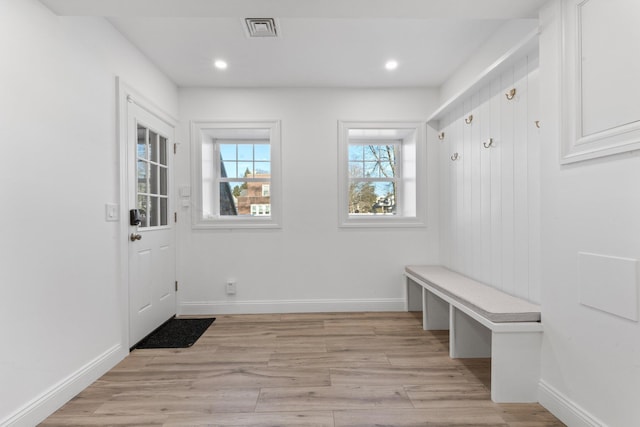 mudroom featuring light wood-style flooring, visible vents, and baseboards