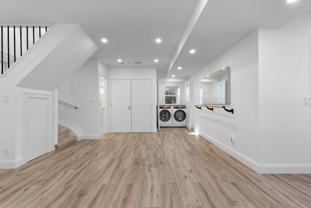 interior space featuring light wood finished floors, recessed lighting, stairway, washer and dryer, and baseboards