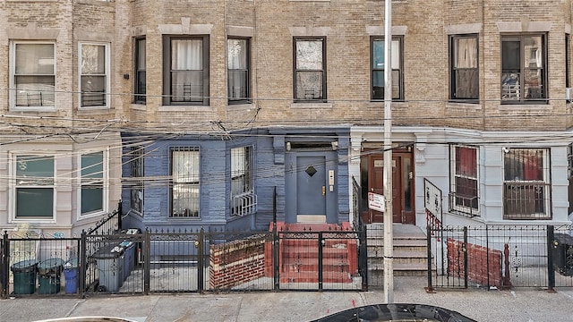 exterior space featuring a fenced front yard and entry steps