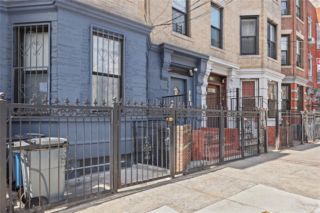 view of building exterior with a fenced front yard