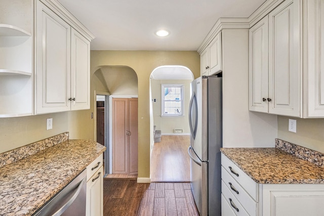 kitchen with white cabinets, appliances with stainless steel finishes, open shelves, and dark wood-style flooring