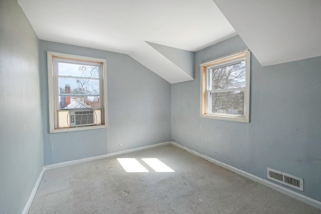 bonus room featuring lofted ceiling, carpet floors, visible vents, and a wealth of natural light