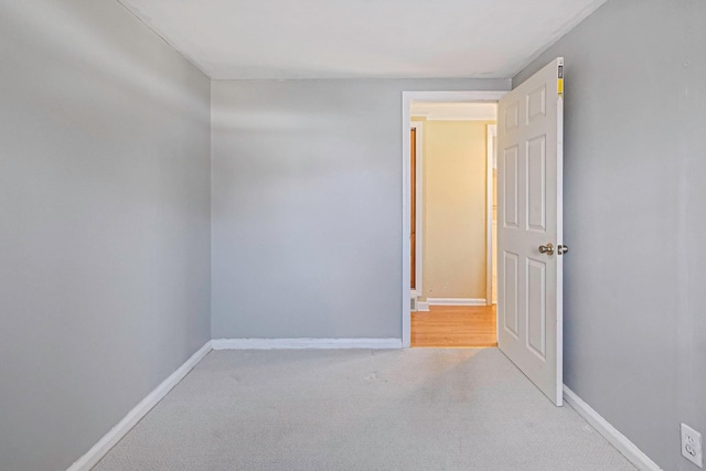 empty room with carpet and baseboards