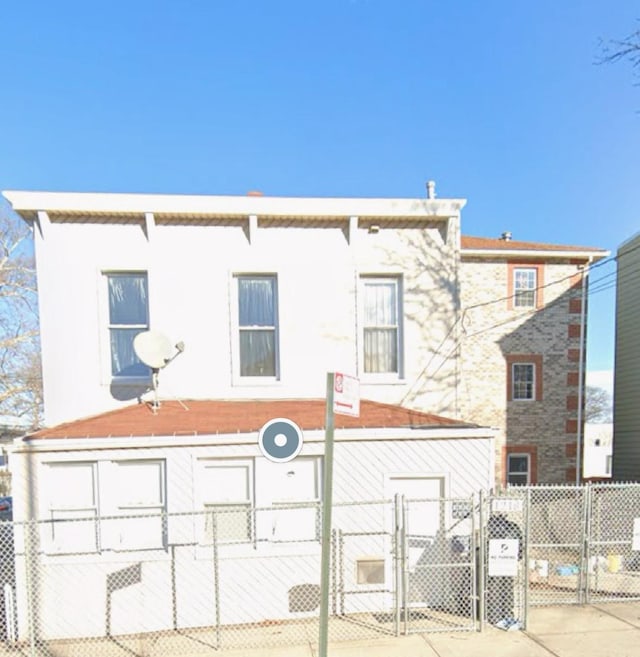 view of front of home with a fenced front yard and a gate