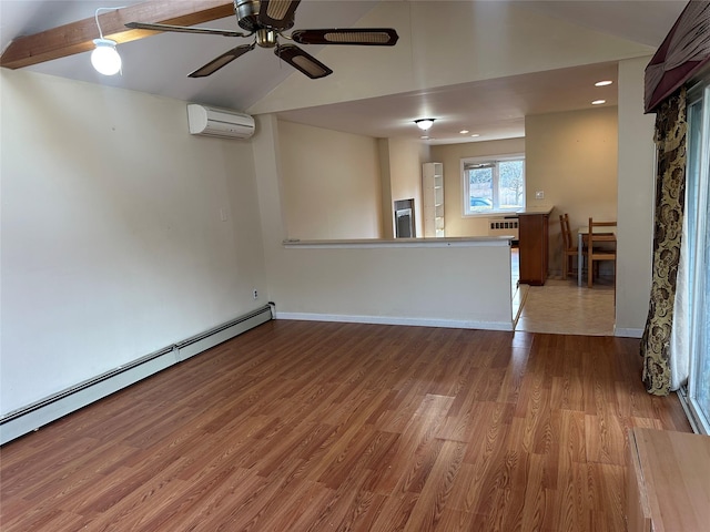 spare room featuring baseboards, a baseboard radiator, wood finished floors, a wall mounted air conditioner, and vaulted ceiling