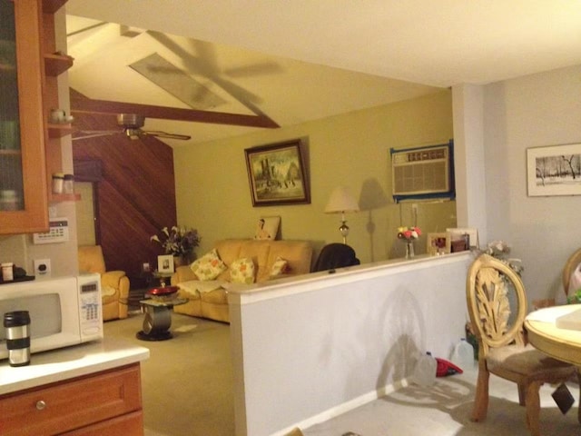 carpeted living area featuring a wall mounted air conditioner and a ceiling fan