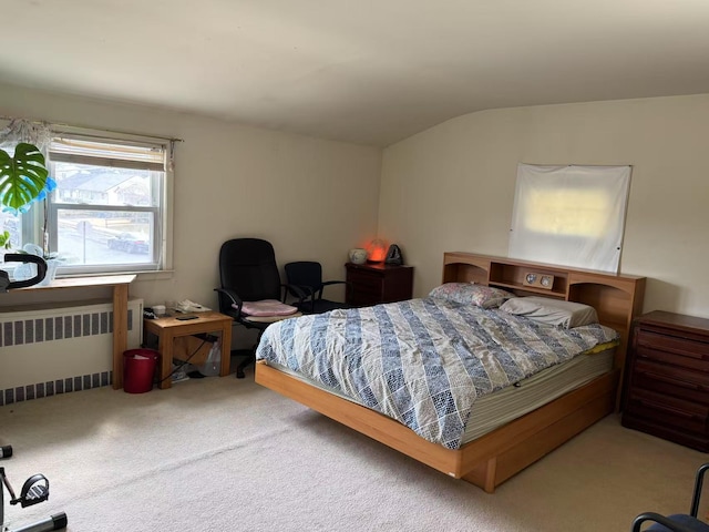 bedroom featuring vaulted ceiling, carpet floors, and radiator heating unit