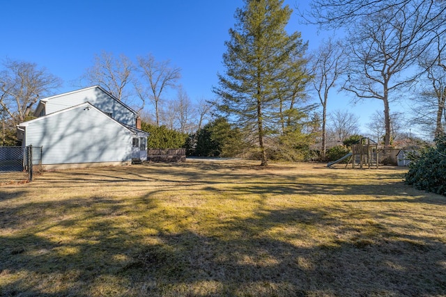 view of yard with a playground and fence