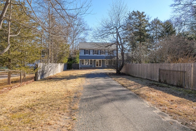 view of front facade featuring driveway and fence private yard