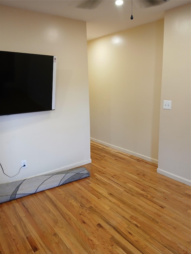 unfurnished living room with baseboards, recessed lighting, and light wood-style floors