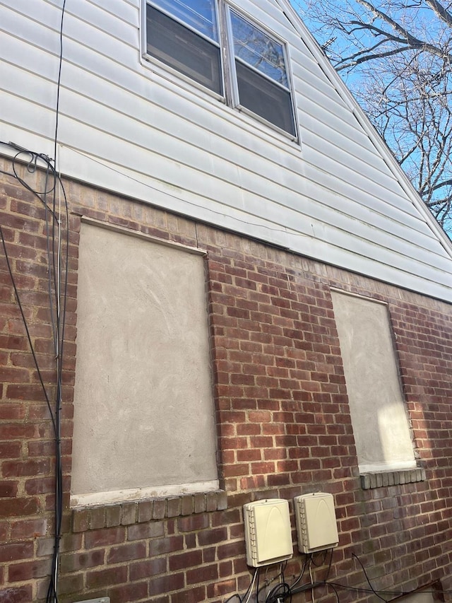 view of property exterior with brick siding