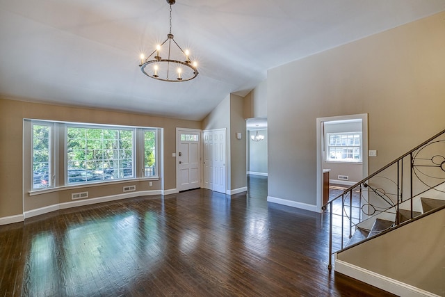 entryway featuring a wealth of natural light, a notable chandelier, and wood finished floors