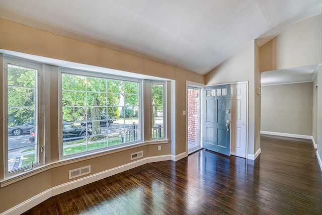 empty room featuring lofted ceiling, visible vents, and a healthy amount of sunlight