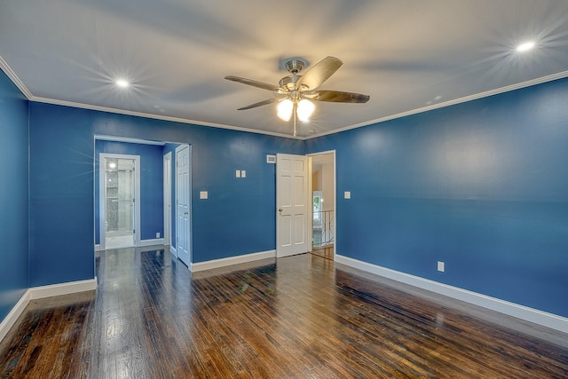 empty room with crown molding, baseboards, and wood finished floors