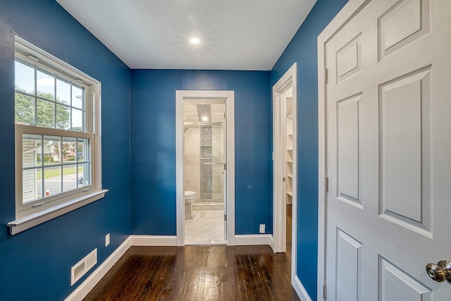 entryway featuring visible vents, baseboards, and wood finished floors