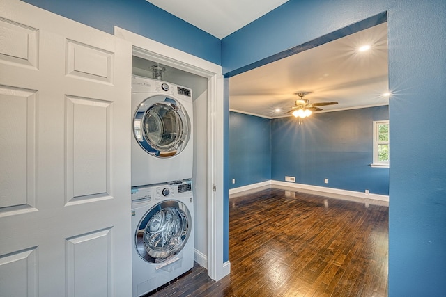 washroom with stacked washer and clothes dryer, dark wood finished floors, ceiling fan, laundry area, and baseboards