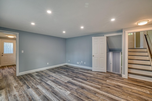 below grade area with stairs, recessed lighting, dark wood finished floors, and baseboards