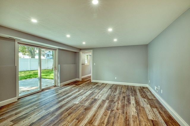 unfurnished room with recessed lighting, baseboards, and wood finished floors