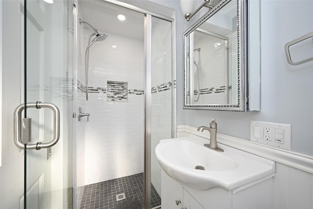 bathroom featuring a shower stall and vanity