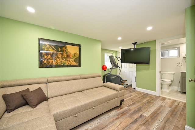 living room with baseboards, wood finished floors, and recessed lighting