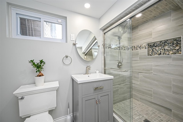 full bath featuring toilet, a shower stall, and vanity