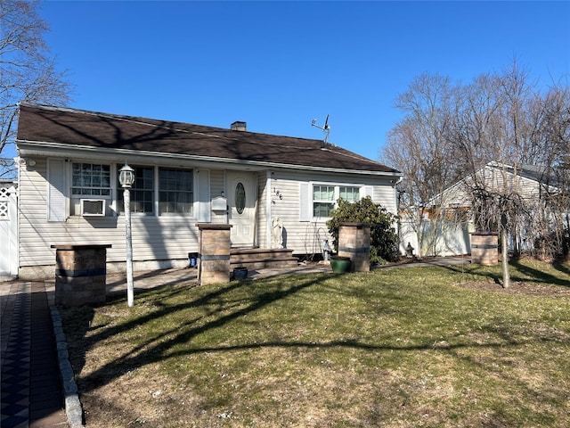 rear view of property with a lawn